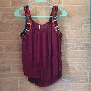 A purple tank top with beaded shoulders.